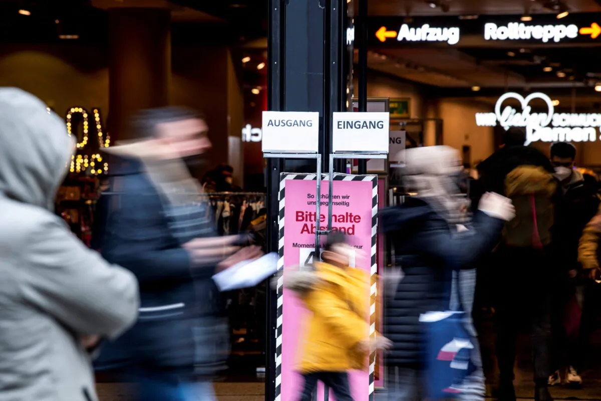 People walk past a store in the pedestrian zone in Munich, Germany, on Dec. 6, 2021. (Lukas Barth/Reuters)
