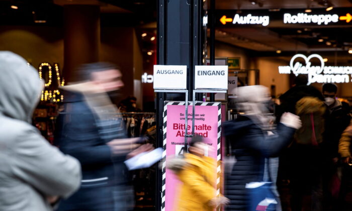 People walk past a store in the pedestrian zone in Munich, Germany, on Dec. 6, 2021. (Lukas Barth/Reuters)