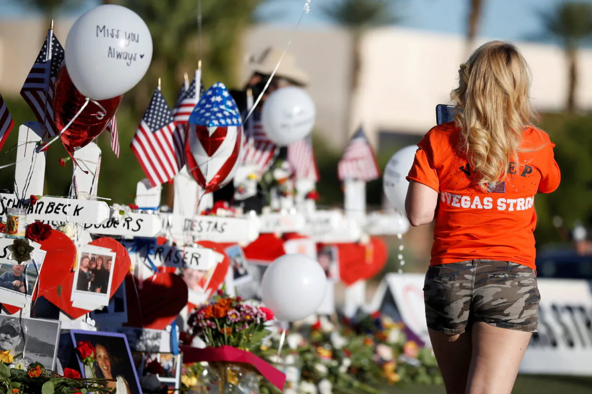 A woman looks at white crosses set up for the victims of the Route 91 Harvest music festival mass shooting in Las Vegas, Nev., on Oct. 7, 2017. (Chris Wattie/Reuters)