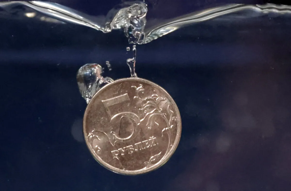 Ruble coin plunges into water in this illustration taken, on May 23, 2022. (Dado Ruvic/Illustration/Reuters)
