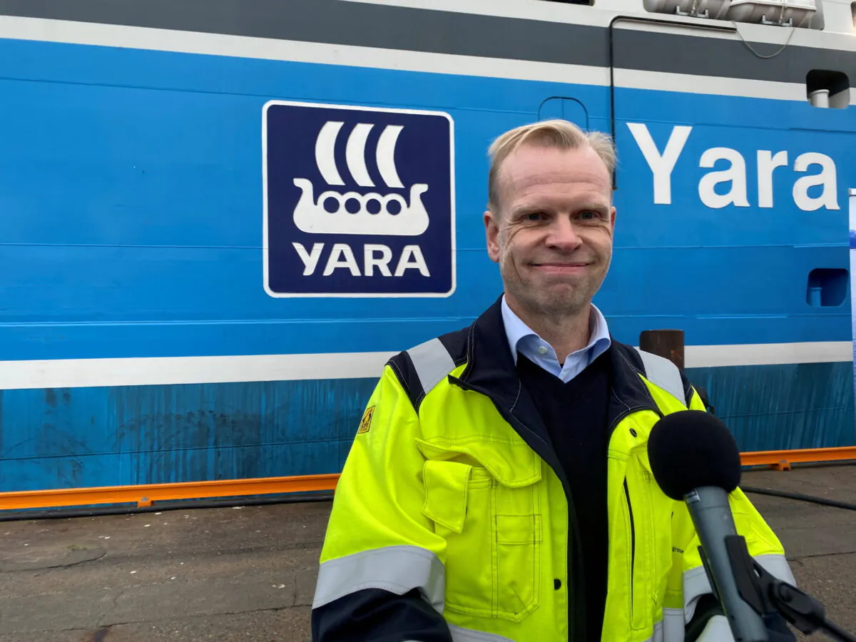 Yara International CEO Svein Tore Holsether stands next to Yara Birkeland, the world's first fully electric and autonomous container vessel, in Oslo, Norway, on Nov. 19, 2021. (Victora Klesty/Reuters)