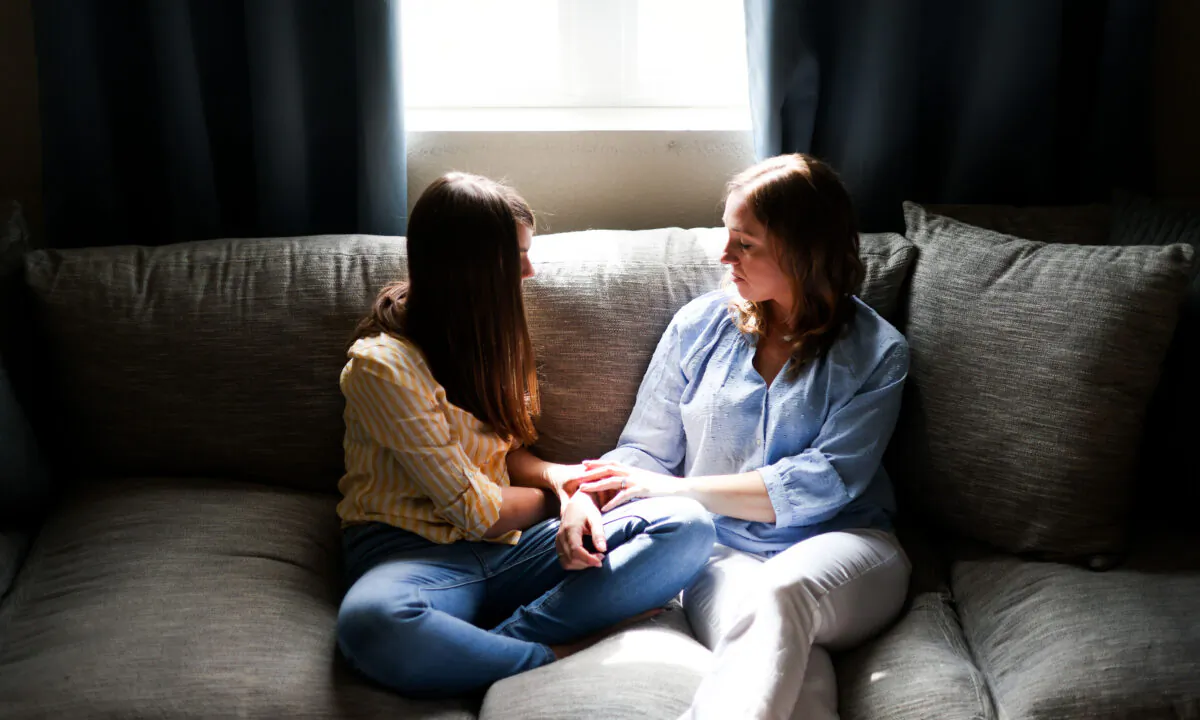 Erin Lee (R) poses for a portrait with her 13-year-old daughter, who wished to remain anonymous, at their home in Wellington, Colo., on May 7, 2022. Lee’s daughter was invited to an after-school art club last year by the Wellington Middle School art teacher, but the club was teaching gender and sexuality awareness topics instead, according to Lee. (Michael Ciaglo for The Epoch Times)