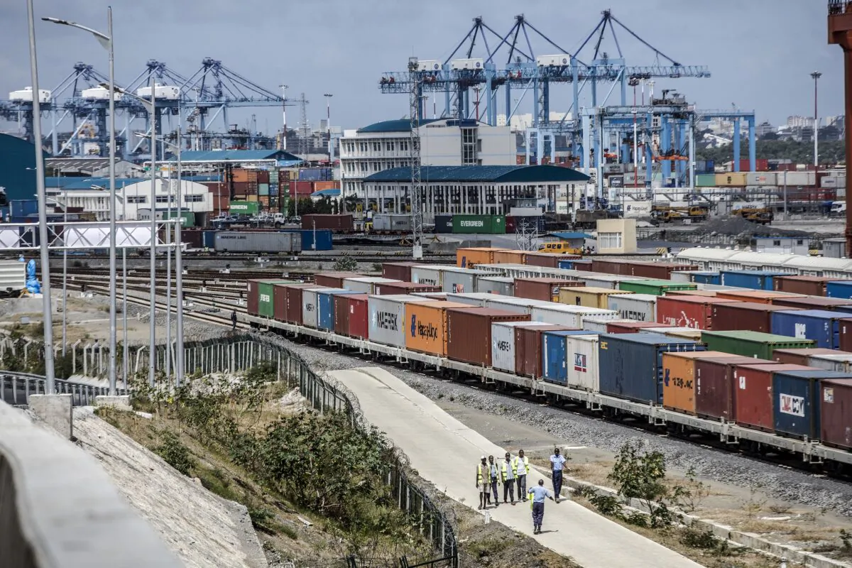 Shipping containers sit beside railway lines running into Mombasa port in Mombasa, Kenya, on Sept. 1, 2018. China's Belt and Road Initiative aims to revive and extend trading routes connecting China with Central Asia, the Middle East, Africa, and Europe via networks of upgraded or new railways, ports, pipelines, power grids, and highways. (Luis Tato/Bloomberg via Getty Images)
