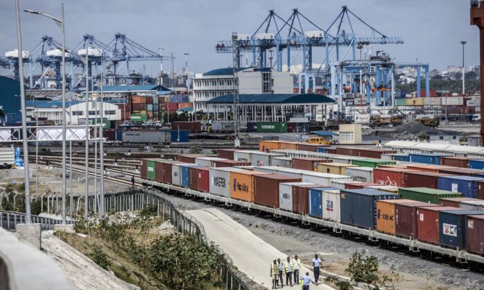 Shipping containers sit beside railway lines running into Mombasa port in Mombasa, Kenya, on Sept. 1, 2018. China's Belt and Road Initiative aims to revive and extend trading routes connecting China with Central Asia, the Middle East, Africa, and Europe via networks of upgraded or new railways, ports, pipelines, power grids, and highways. (Luis Tato/Bloomberg via Getty Images)