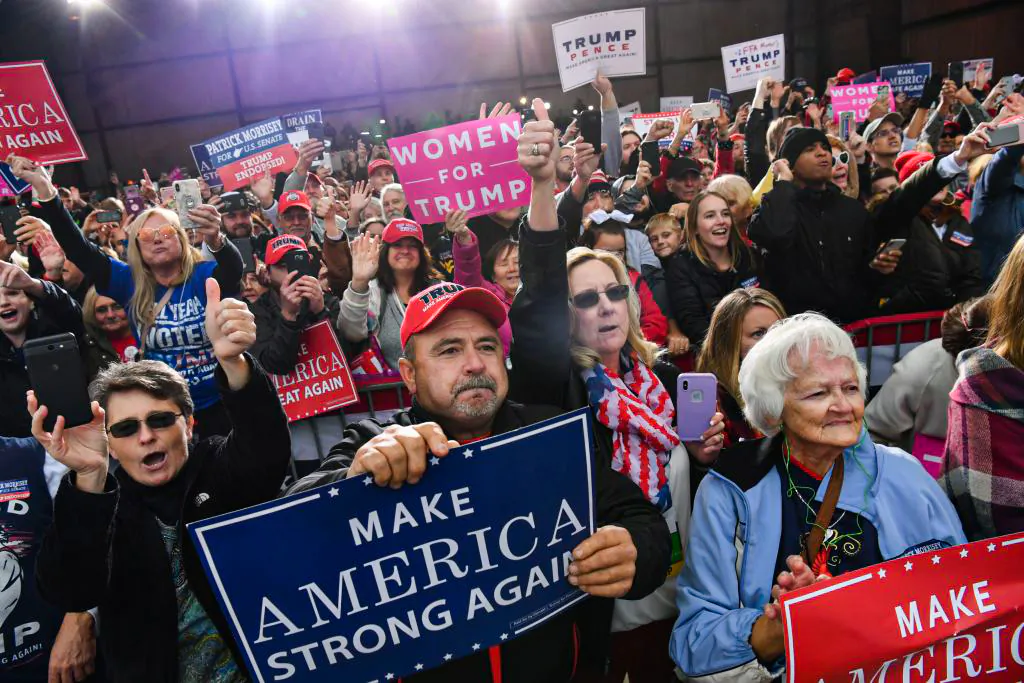 People cheer as US President Donald Trump arrives to speak at a campaign rally at the Huntington Tri-State Airport, on November 2, 2018, in Huntington, West Virginia. (NICHOLAS KAMM/AFP via Getty Images)