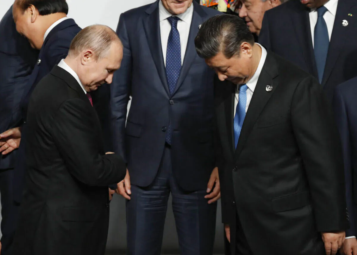 Russian President Vladimir Putin (L) and Chinese leader Xi Jinping before a family photo session at G20 summit in Osaka, Japan, on June 28, 2019. (Kim Kyung-Hoon - Pool/Getty Images)