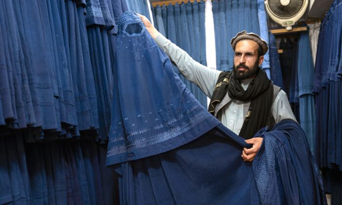 An Afghan vendor displays a burqa at his shop at Mandawi market in Kabul, Afghanistan, on May 8, 2022. (Wakil Kohsar/AFP via Getty Images)