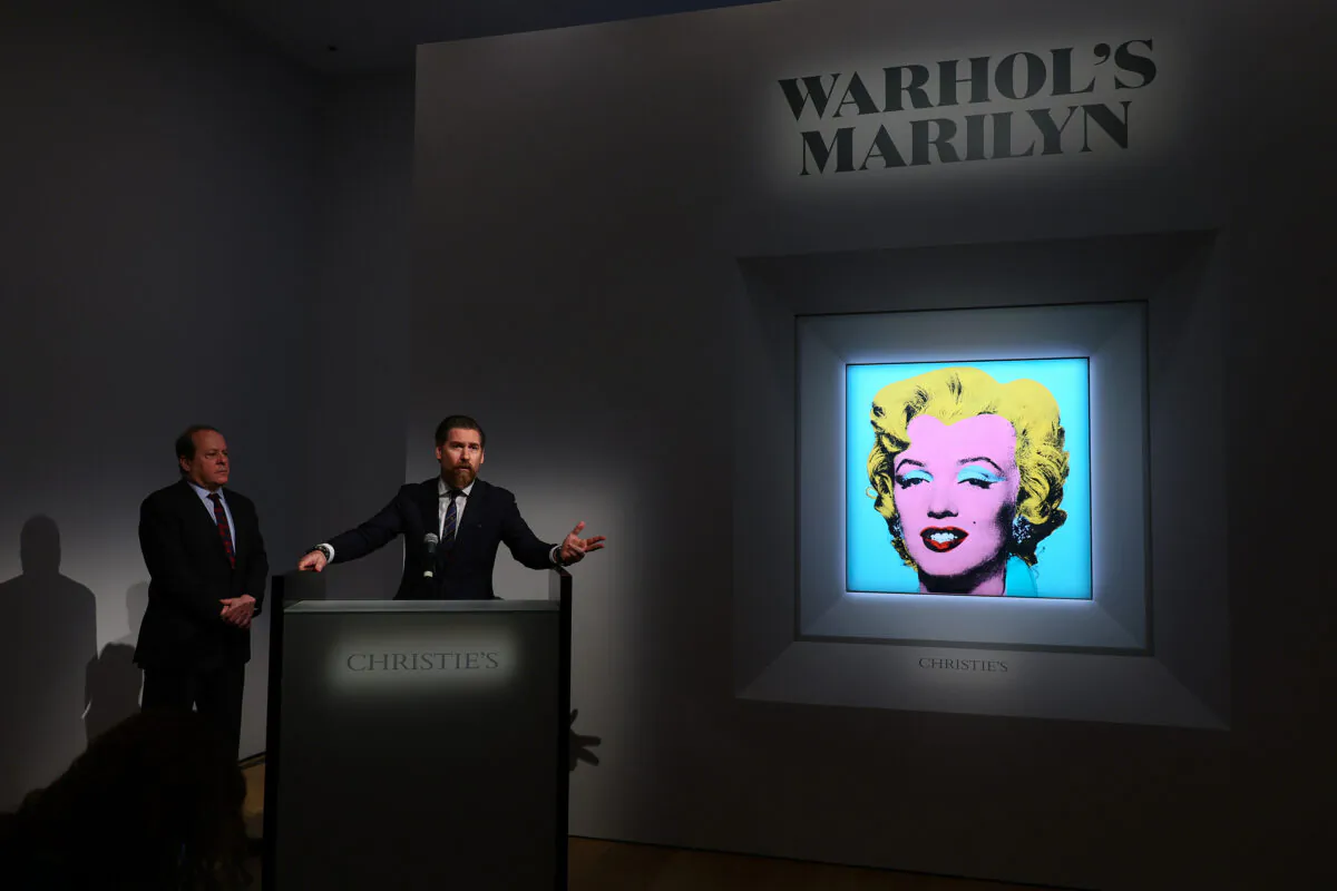 Christie’s Americas chairman Marc Porter (L) looks on as Christie's chairman, 20th and 21st Century Art, Alex Rotter announces that Christie's will offer Andy Warhol’s "Shot Sage Blue Marilyn" painting of Marilyn Monroe during its May Marquee Week of sales at Christie’s in New York City on March 21, 2022. (Dia Dipasupil/Getty Images)