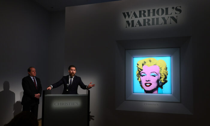Christie’s Americas chairman Marc Porter (L) looks on as Christie's chairman, 20th and 21st Century Art, Alex Rotter announces that Christie's will offer Andy Warhol’s "Shot Sage Blue Marilyn" painting of Marilyn Monroe during its May Marquee Week of sales at Christie’s in New York City on March 21, 2022. (Dia Dipasupil/Getty Images)
