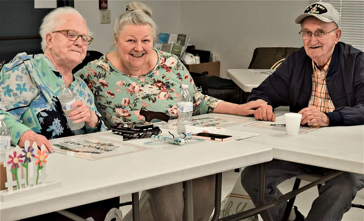 Ria Foltz, 86; Christine Kuss, 71; and Tom Schultz, 85, get ready to play Bingo at the Millersville Senior Center in Millersville, Penn., on May 9, 2022. (Beth Brelje/ The Epoch Times)