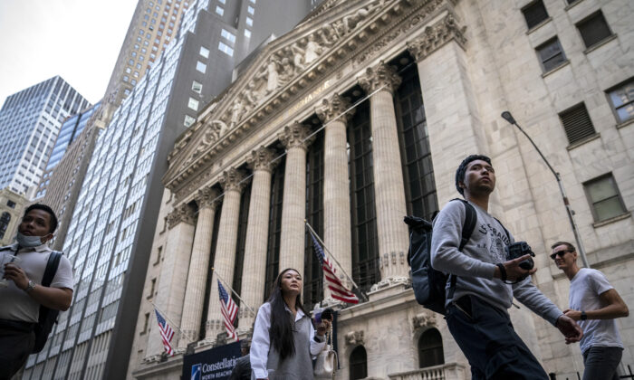 Pedestrians pass the New York Stock Exchange on May 5, 2022. (John Minchillo/AP Photo)