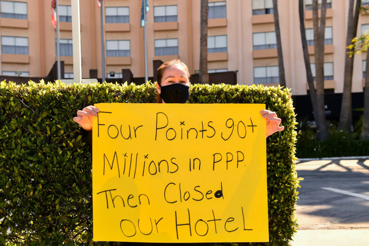 A worker protests outside the closed Four Points by Sheraton LAX hotel as they call for an investigation by the U.S. Small Business Administration (SBA) into the use of Paycheck Protection Program (PPP) loan funds in Los Angeles, Calif., on April 7, 2021. (Patrick T. Fallon/AFP via Getty Images)