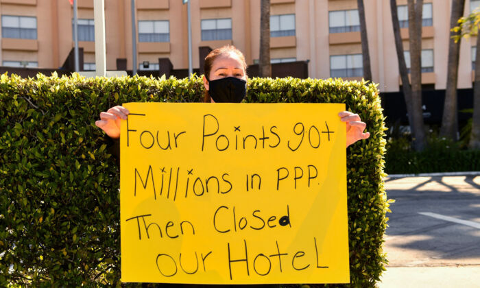 A worker protests outside the closed Four Points by Sheraton LAX hotel as they call for an investigation by the U.S. Small Business Administration (SBA) into the use of Paycheck Protection Program (PPP) loan funds in Los Angeles, Calif., on April 7, 2021. (Patrick T. Fallon/AFP via Getty Images)