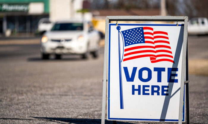A vote here sign in a parking lot. (Mike Flipp/Shutterstock)