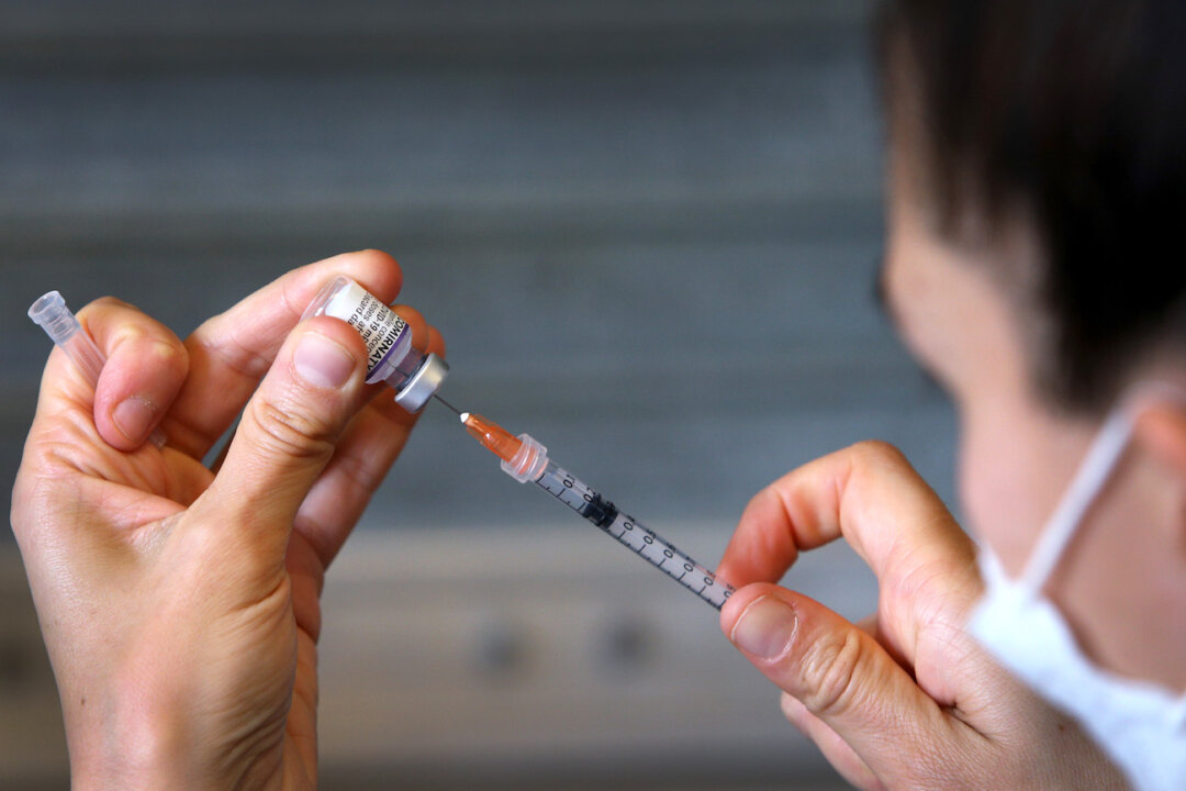A nurse prepares a Pfizer vaccine overseen by a doctor in Sydney, Australia, on Oct. 3, 2021. (Lisa Maree Williams/Getty Images)