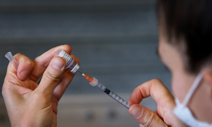 A nurse prepares a Pfizer vaccine overseen by a doctor in Sydney on Oct. 3, 2021. (Lisa Maree Williams/Getty Images)