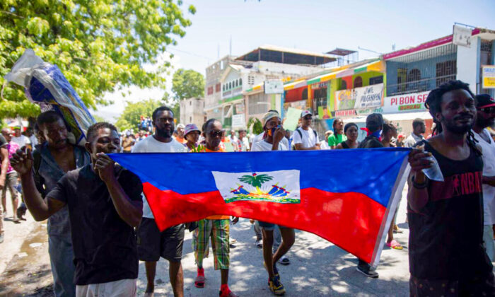 Demonstrators march demanding peace and security in La Plaine neighborhood of Port-au-Prince, Haiti, on May 6, 2022. (Odelyn Joseph/AP Photo)
