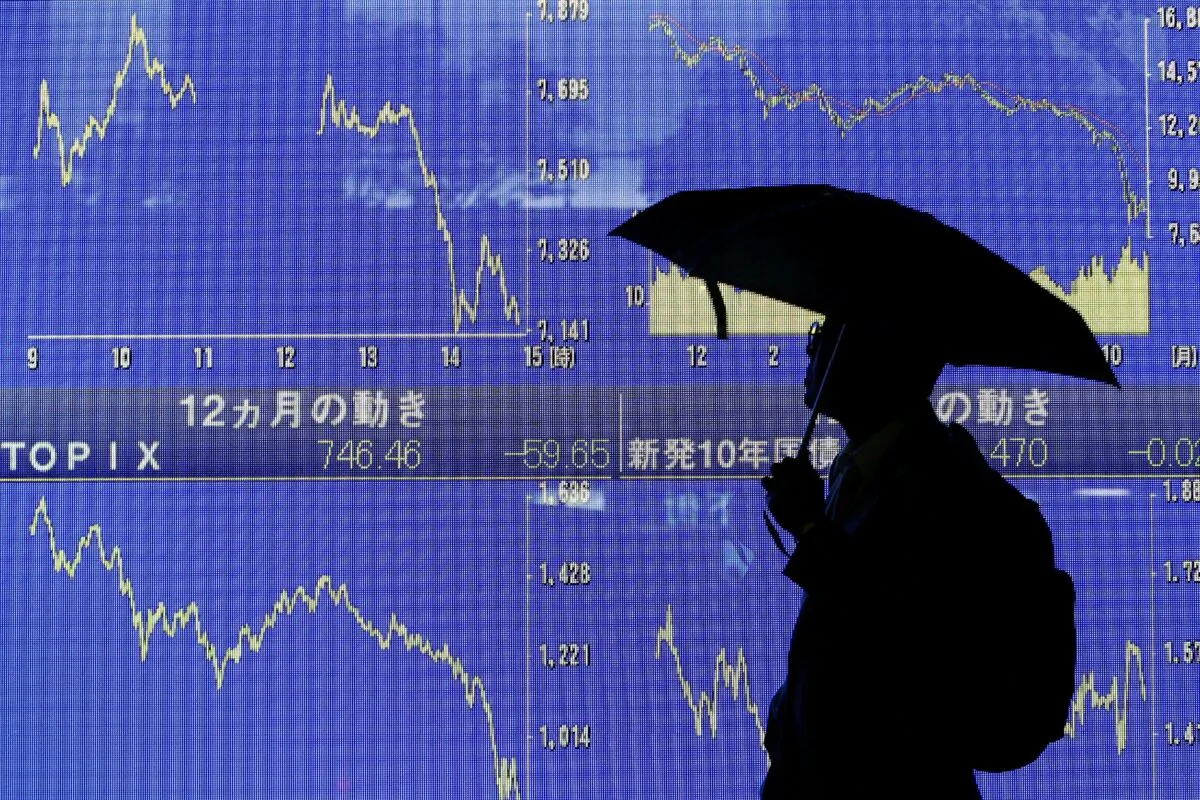 A man looks at an electronic board showing the downward trend of Japan's Nikkei share average on Oct. 27, 2008 in Tokyo. (Kiyoshi Ota/Getty Images)