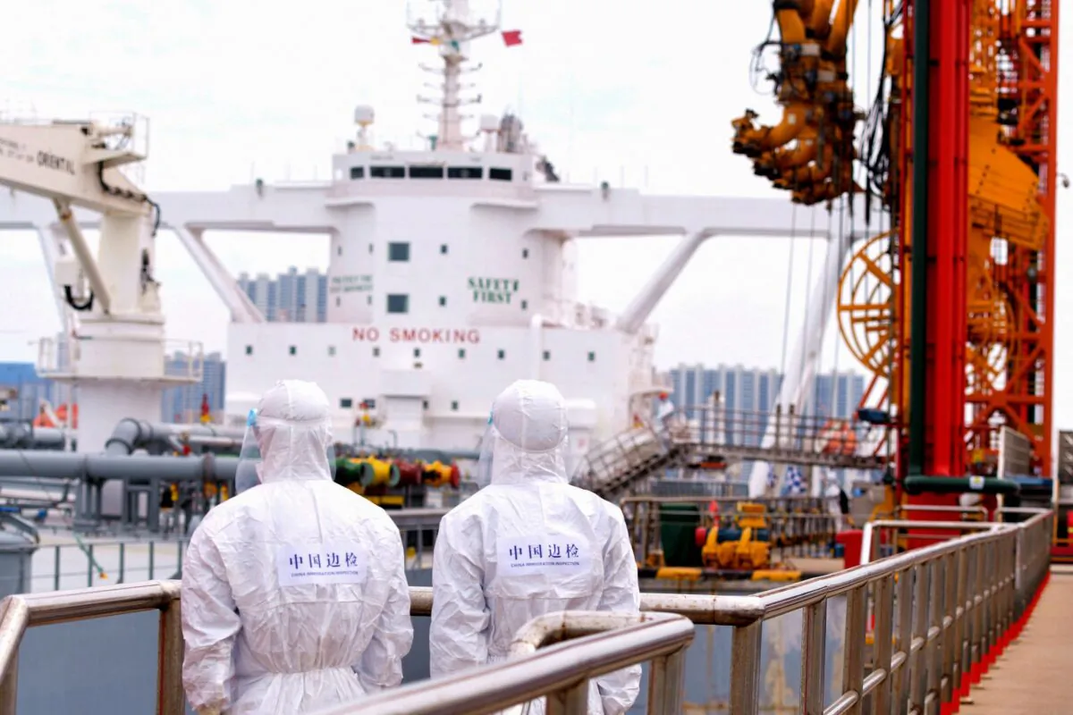 Immigration inspection officers check an oil tanker carrying imported crude oil at Qingdao port in China's eastern Shandong province on May 9, 2022. (STR/AFP via Getty Images)