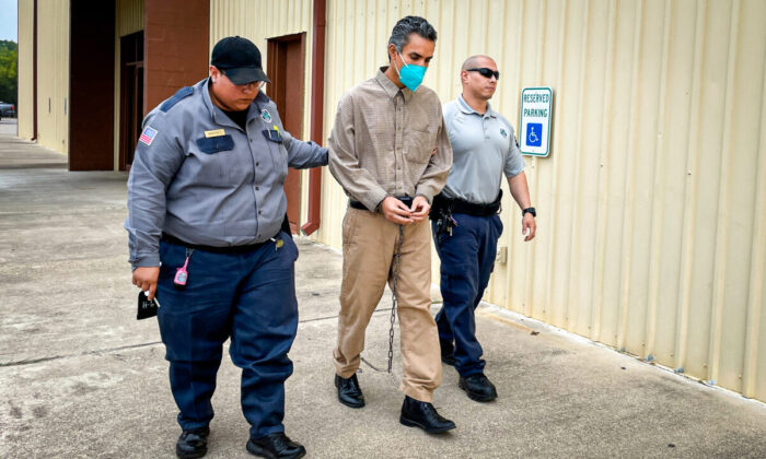 Lester Hidalgo Aguilar (C) is escorted from the Kinney County Civic Center before his trial for trespassing on a local ranch, in Brackettville, Texas, on May 9, 2022. (Charlotte Cuthbertson/The Epoch Times)