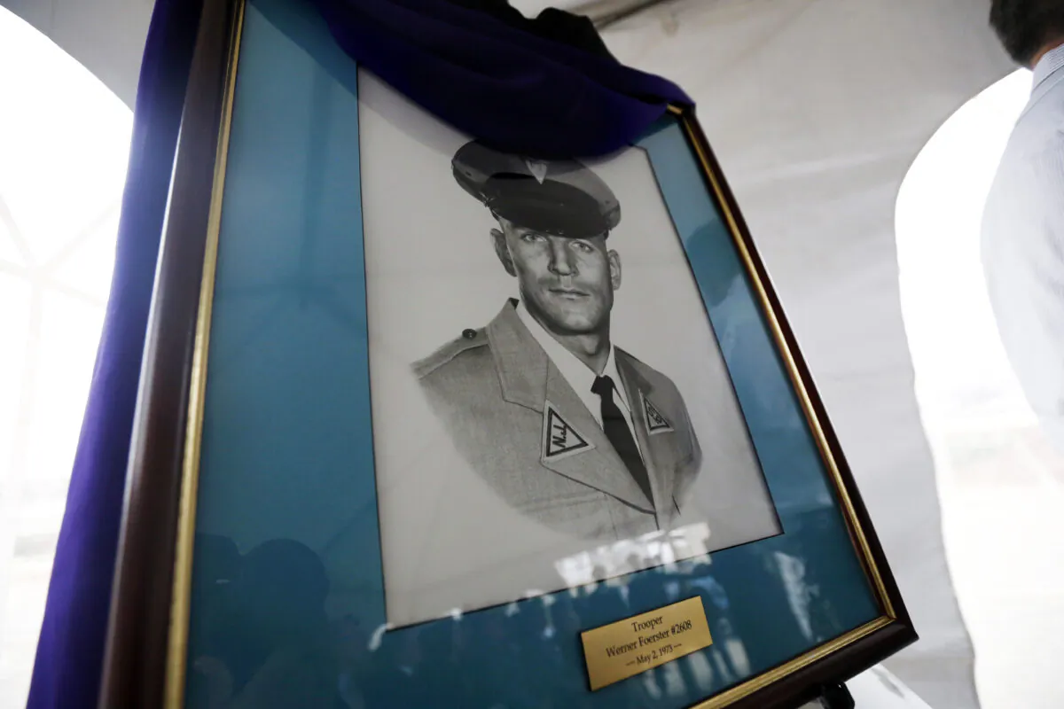 A portrait of New Jersey State Police trooper Werner Foerster, who was killed during a stop on the New Jersey Turnpike in 1973, is displayed during an event unveiling a monument in his honor in East Brunswick, N.J., on Nov. 18, 2015. (Julio Cortez/ AP Photo)