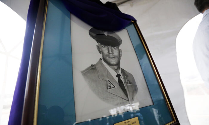A portrait of New Jersey State Police trooper Werner Foerster, who was killed during a stop on the New Jersey Turnpike in 1973,  is displayed during an event unveiling a monument in his honor in East Brunswick, N.J., on Nov. 18, 2015. (Julio Cortez/ AP Photo)