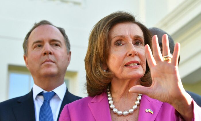 Rep. Adam Schiff (D-Calif.) listens as House Speaker Nancy Pelosi (D-Calif.), alongside members of the Congressional delegation that recently visited Ukraine, speaks to reporters following a meeting with President Joe Biden at the White House in Washington, on May 10, 2022. (Nicholas Kamm/AFP via Getty Images)