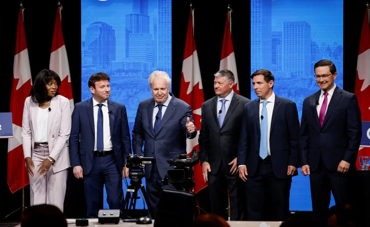 Conservative Party leadership candidates pose on stage following the Conservative Party of Canada English leadership debate in Edmonton on May 11, 2022. (The Canadian Press/Jeff McIntosh)