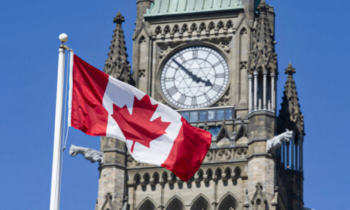 The Canadian flag flies near the Peace Tower on Parliament Hill in Ottawa on June 17, 2020. (Adrian Wyld/The Canadian Press)