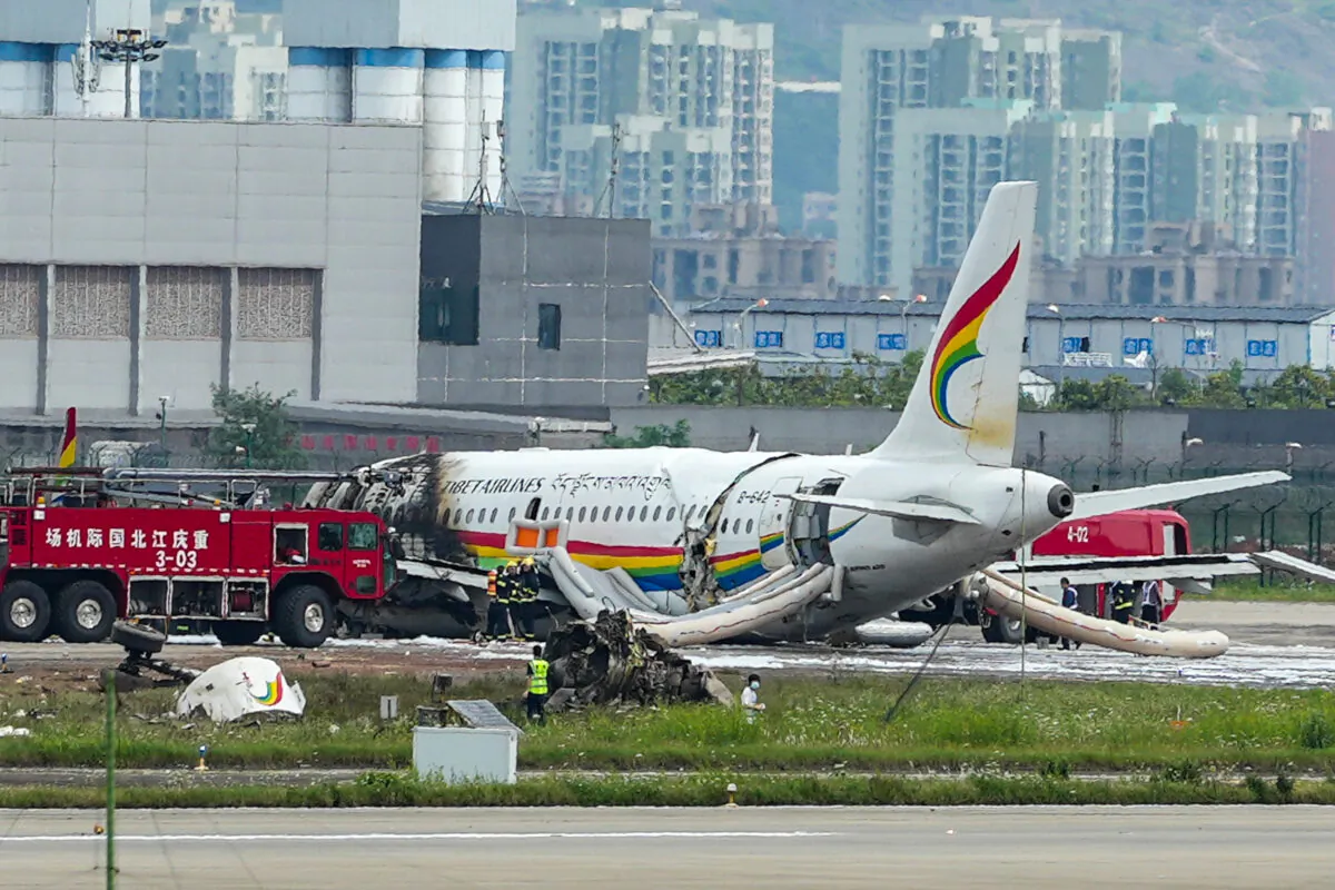 A passenger jet that veered off a runway during take-off and caught fire is seen in the aftermath in Chongqing Jiangbei International Airport in southwestern China's Chongqing on May 12, 2022. (Liu Chan/Xinhua via AP)
