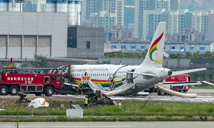 A passenger jet that veered off a runway during take-off and caught fire is seen in the aftermath in Chongqing Jiangbei International Airport in southwestern China's Chongqing on May 12, 2022. (Liu Chan/Xinhua via AP)