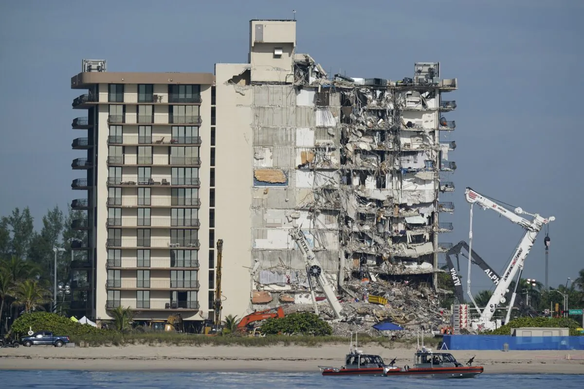 Coast Guard boats patrol in front of the partially collapsed Champlain Towers South condo building, in Surfside, Fla., on July 1, 2021. (Mark Humphrey/AP Photo)
