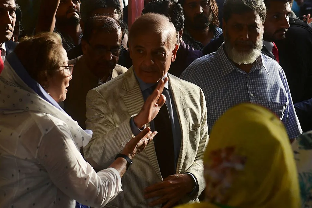 Pakistan's Prime Minister Shehbaz Sharif waves as he arrives to meet leaders of the Muttahida Qaumi Movement (MQM-P) and collation partners of the newly formed government during his visit in Karachi on April 13, 2022. (Asif Hassan/AFP via Getty Images)