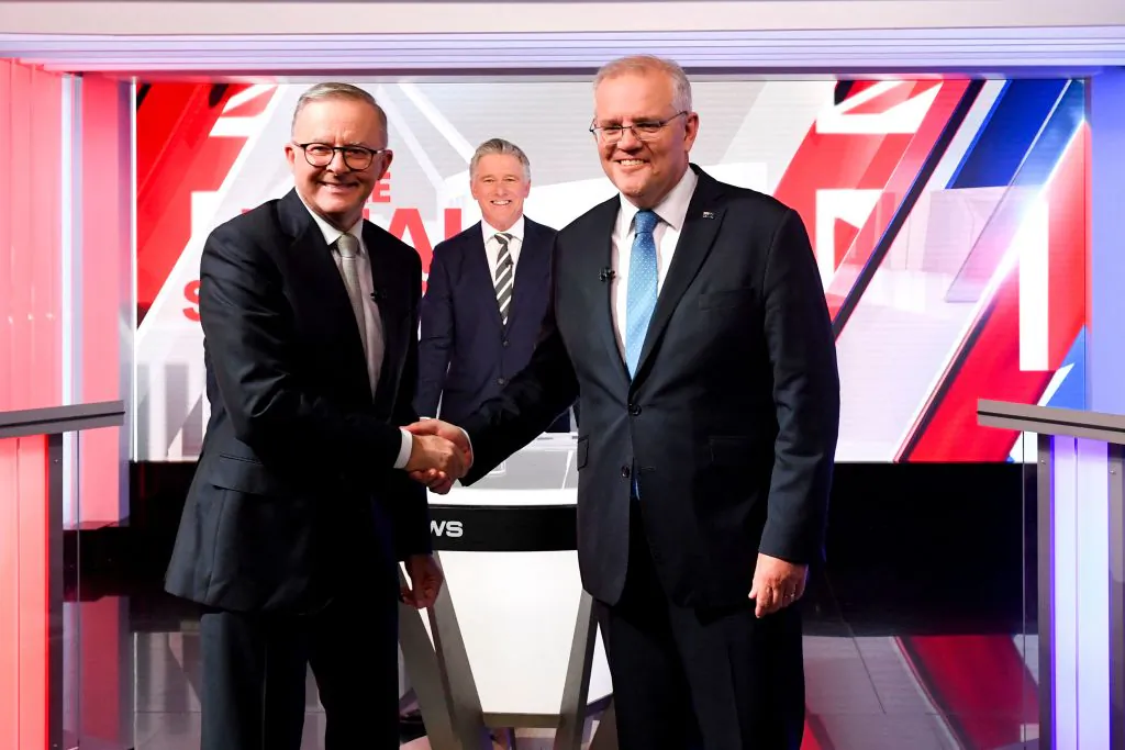 Australian Prime Minister Scott Morrison (R) and leader of the opposition, Anthony Albanese shake hands at the final leaders' debate of the 2022 at Seven Network Studios in Sydney, Australia on May 11, 2022. (Lukas Coch/POOL/AFP via Getty Images)