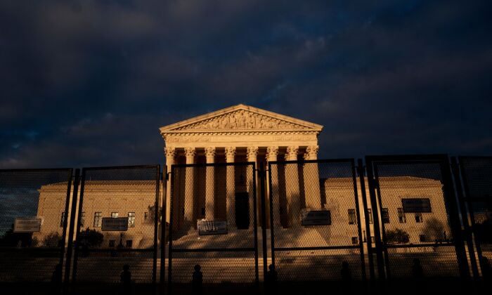 The U.S. Supreme Court is seen behind fences in Washington, D.C., on May 11, 2022. (Stefani Reynolds/AFP via Getty Images)