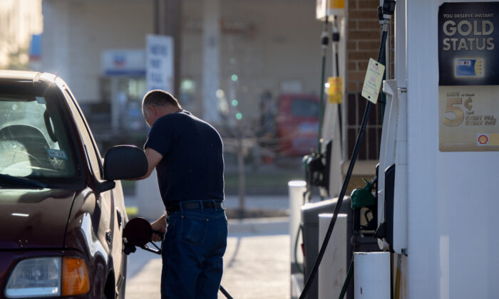 A man pumps gas at a Shell gas station in Houston, Texas on April 1, 2022. (Brandon Bell/Getty Images)