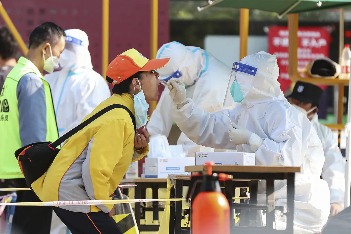 A resident gets a swab at a Covid-19 test site on May 11, 2022 in Beijing. (Lintao Zhang/Getty Images)