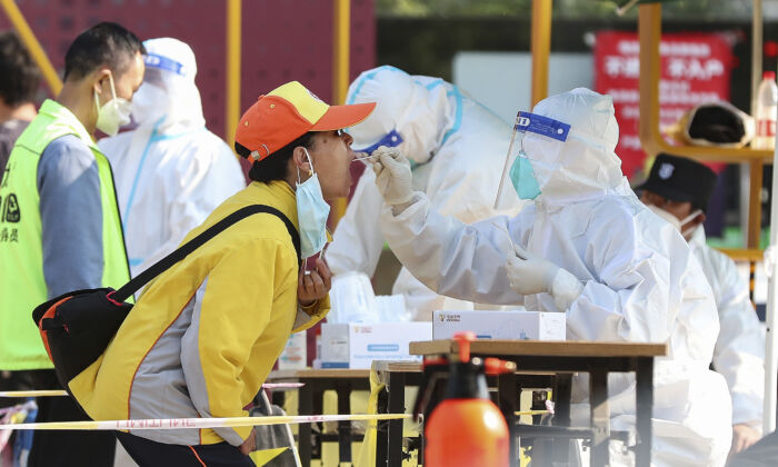 A resident gets a swab at a Covid-19 test site on May 11, 2022 in Beijing. (Lintao Zhang/Getty Images)