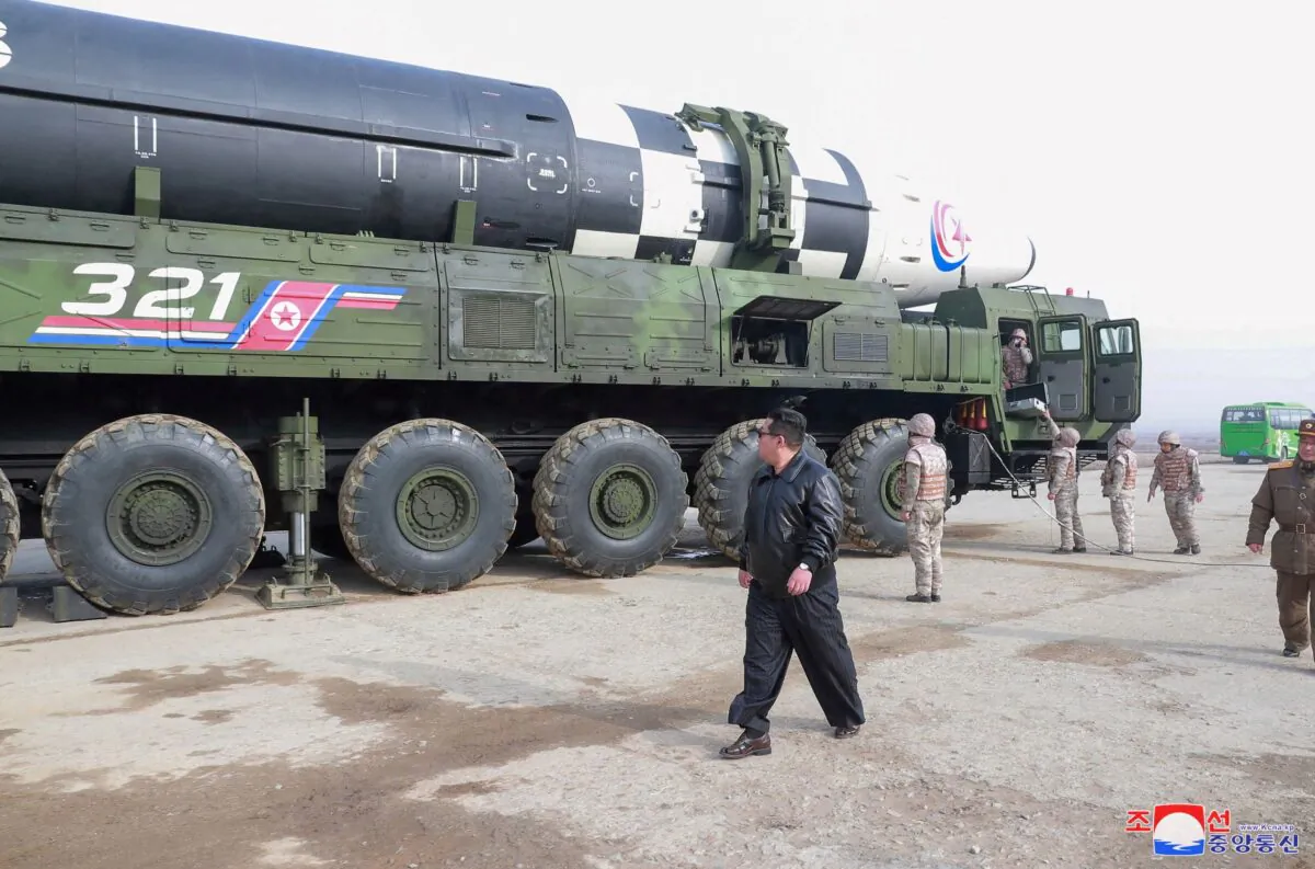 North Korean leader Kim Jong Un walks next to what state media reports is the "Hwasong-17" intercontinental ballistic missile (ICBM) on its launch vehicle in an undated photo released on March 25, 2022. (KCNA via Reuters)