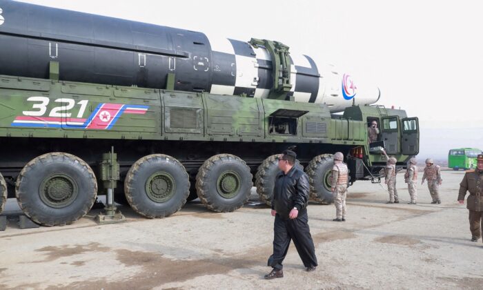 North Korean leader Kim Jong Un walks next to what state media reports is the "Hwasong-17" intercontinental ballistic missile (ICBM) on its launch vehicle in an undated photo released on March 25, 2022. (KCNA via Reuters)