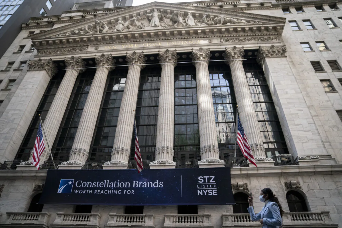 Pedestrians pass the New York Stock Exchange on May 5, 2022. (John Minchillo/AP Photo)