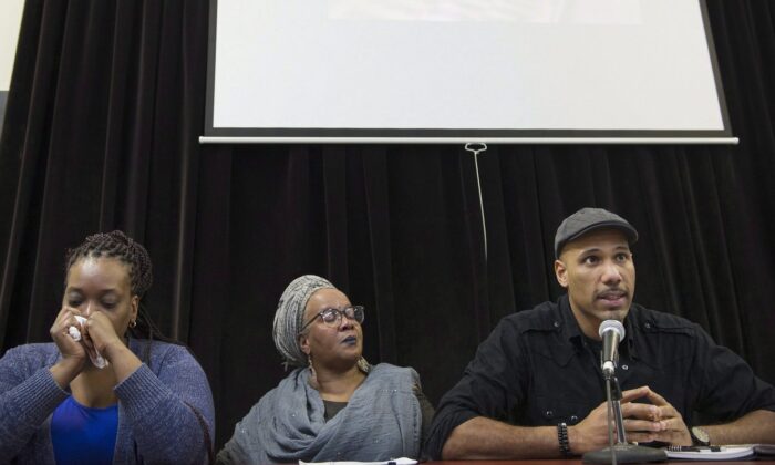 Johanne Coriolan, left, a family member of Pierre Coriolan, and activists Wil Prosper, right, and Maguy Metellus attend a news conference in Montreal, Feb. 7, 2018. (The Canadian Press/Graham Hughes)