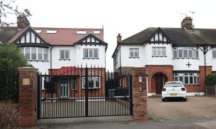 Two neighbouring houses in Chingford, northeast London, on Dec. 30, 2021. (PA Media)