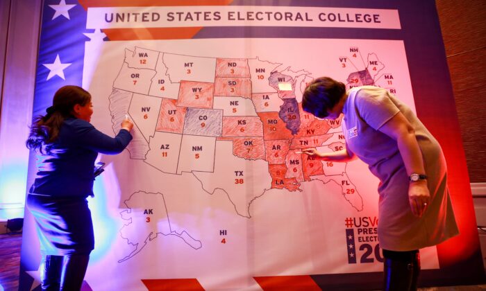 People color in an electoral map during a U.S. presidential election watch party at the U.S. embassy in Ulaanbaatar, Mongolia, on Nov. 4, 2020. (Byambasuren Byamba-Ochir/AFP via Getty Images)