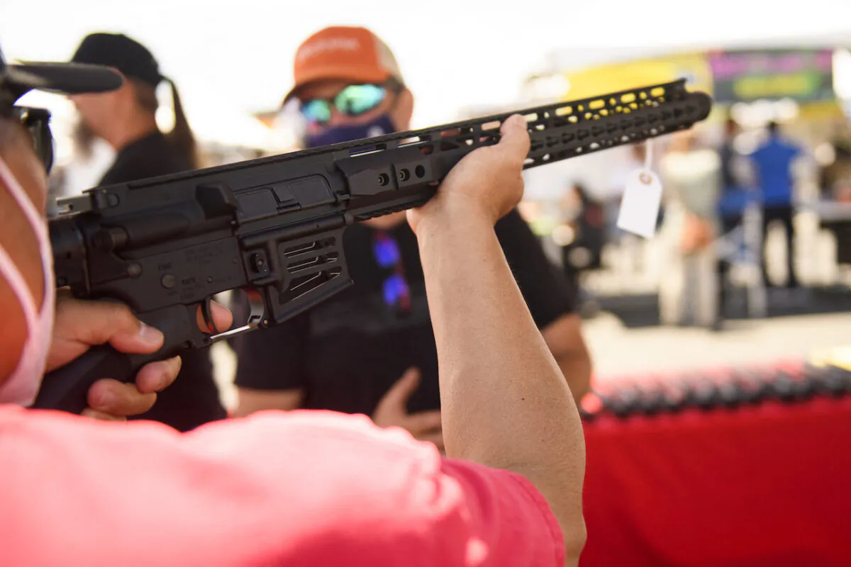 A person holds a California-legal featureless AR-15 style rifle in Costa Mesa, Calif., on June 5, 2021. (Patrick Fallon/AFP via Getty Images)