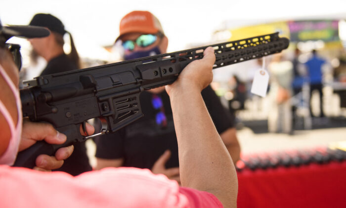A person holds a California-legal featureless AR-15 style rifle in Costa Mesa, Calif., on June 5, 2021. (Patrick Fallon/AFP via Getty Images)
