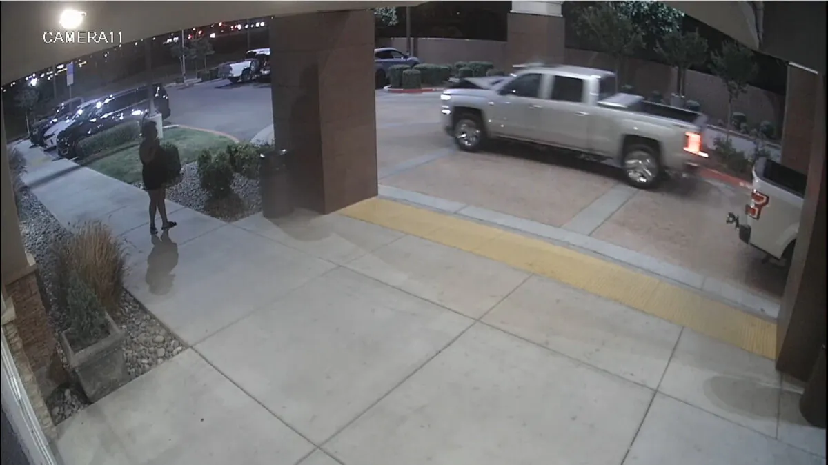 Surveillance video image released by the Fresno Police Department shows a pickup truck that struck a woman leaving a hotel parking lot in Fresno, Calif., on May 13, 2022. (Fresno Police Department via AP)