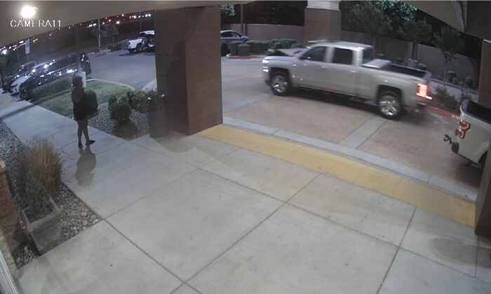 Surveillance video image released by the Fresno Police Department shows a pickup truck that struck a woman leaving a hotel parking lot in Fresno, Calif., on May 13, 2022. (Fresno Police Department via AP)