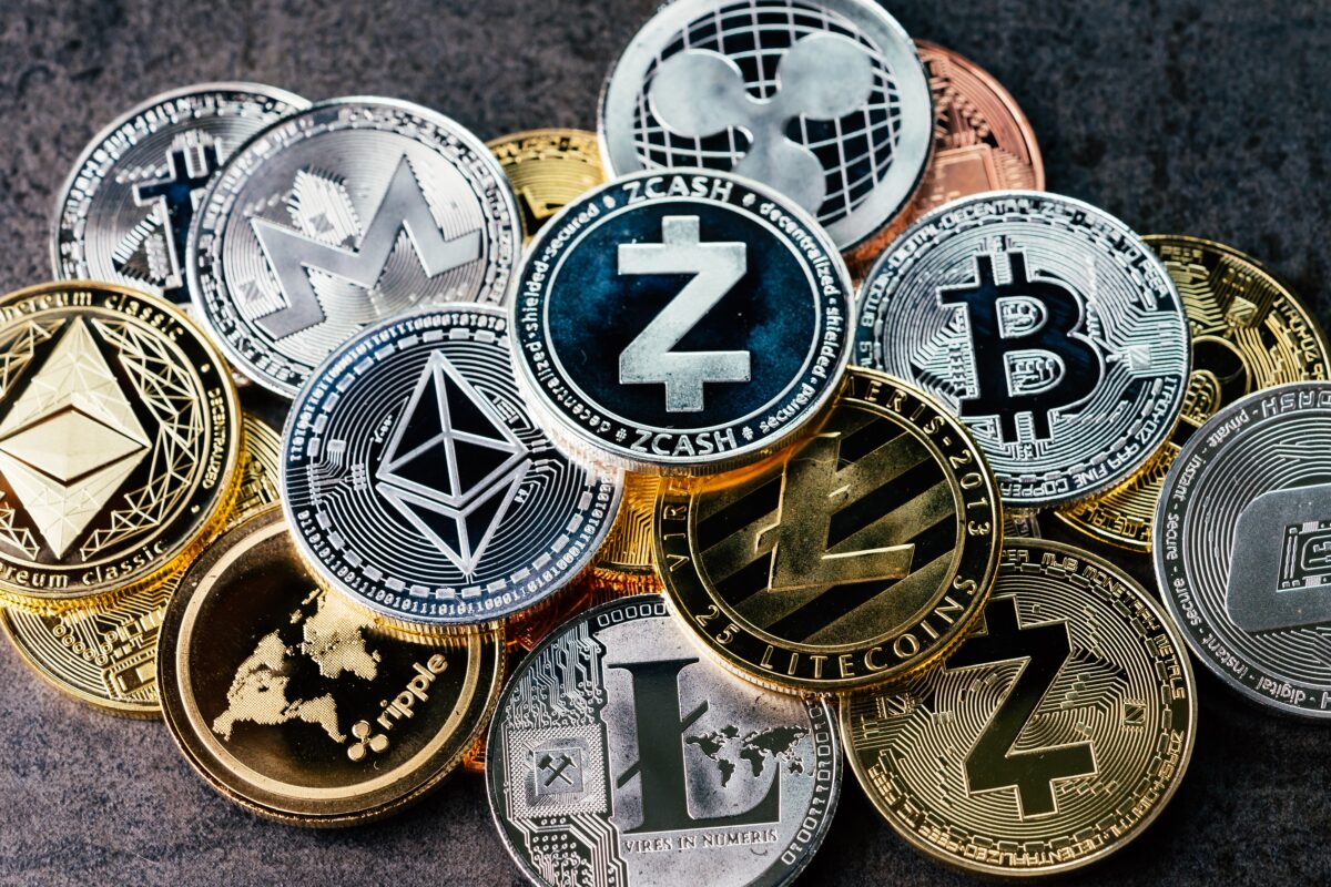 Crypto currency background with various of shiny silver and golden physical cryptocurrencies symbol coins, Bitcoin, Ethereum, Litecoin, zcash, ripple. (eamesBot/ShutterStock)
