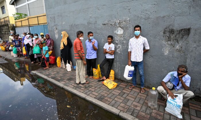 People queue up to buy kerosine for domestic use at a supply station after authorities relaxed the ongoing curfew for a few hours in Colombo on May 12, 2022. (Ishara S. Kodikara/AFP via Getty Images)